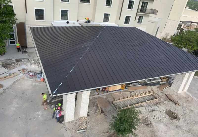 Metal roofing installation team working on a commercial building in Homeland Park